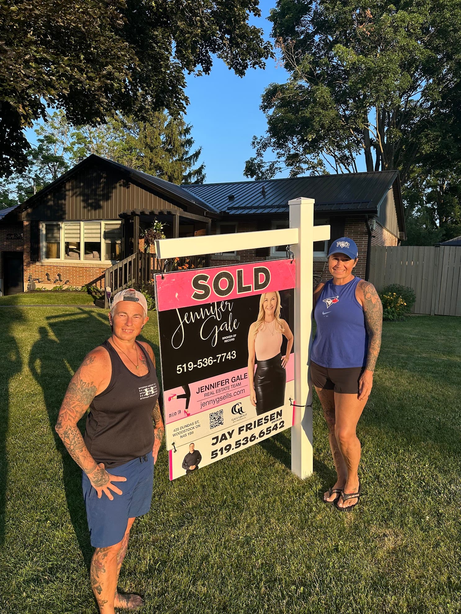 Jay Friesen with happy sellers in front of sold property